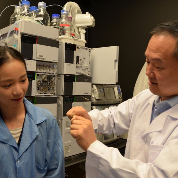 Jian Yang with Ph.D. student Chuying Ma displaying a bendable citrate-based material for bone repair. IMAGE: WALT MILLS / PENN STATE