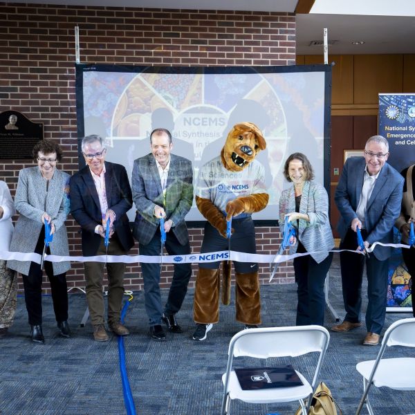 Penn State and U.S. National Science Foundation representatives cut a ribbon celebrating the official launch of the U.S. National Science Foundation National Synthesis Center for Emergence in the Molecular and Cellular Sciences (NCEMS) with the Penn State Nittany Lion mascot. The NCEMS launch took place on Monday, Nov. 18, and provided information about open calls for working groups, fellowships and internships, as well as a growth trajectory over the next five years. Credit: Keith Hickey/Huck Institutes. All Rights Reserved.