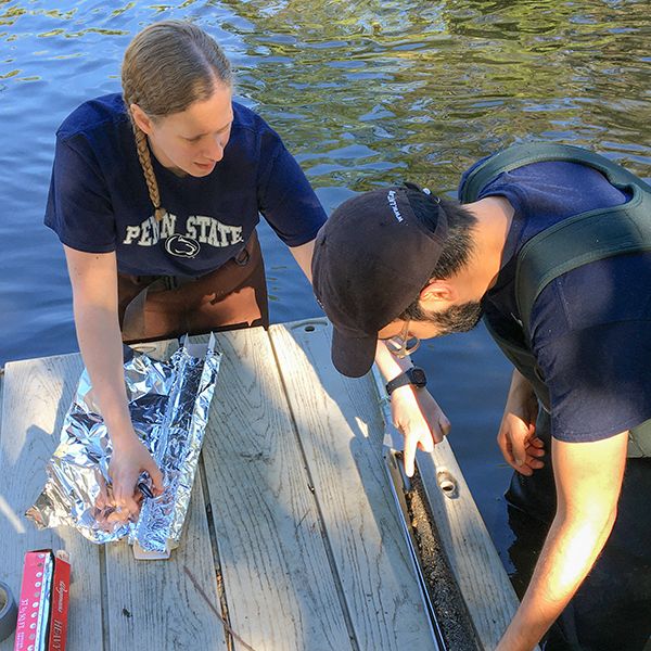 Jill Arriola, left, and Daniel Guarin collecting cores at the inlet to the John Heinz National Wildlife Refuge at Tinicum, which houses the largest remaining freshwater tidal marsh in Pennsylvania. Credit: Lisa Emili. All Rights Reserved.