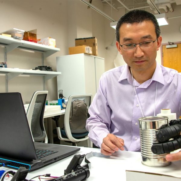 In his research, Xiaogang Hu, Dorothy Foehr Huck and J. Lloyd Huck Chair in Neurorehabilitation and an associate professor of mechanical engineering at Penn State, focuses on creating wearable assistive robotic systems for people with limited use of their limbs, especially their hands, with the goal of the user intuitively controlling the systems and devices on which they rely.  Credit: Kate Myers/Penn State. All Rights Reserved.